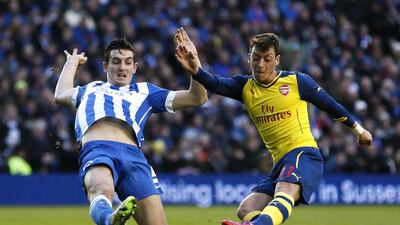 Arsenal's Mesut Ozil shoots and scores his side's second goal to make it 2-0 in an eventual 3-2 win in the fourth round of the FA Cup on Sunday against Brighton. Stefan Wermuth / Reuters