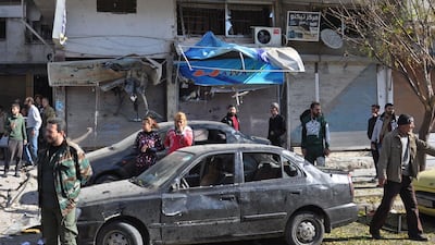 Emergency services and civilians gather at the scene of a car bomb explosion in a predominantly pro-government neighbourhood of the Syrian city of Homs on Tuesday afternoon. AFP