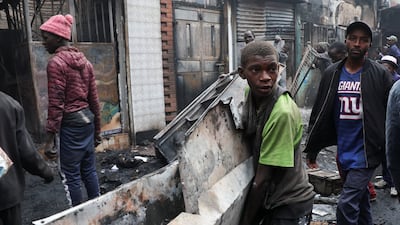 Metal is salvaged from businesses burnt during demonstrations to mark the first anniversary of deadly anti-government protests, in Nairobi, Kenya. Reuters