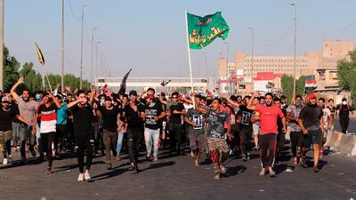 Anti-government protesters chant slogans during a demonstration in Baghdad, Iraq. AP