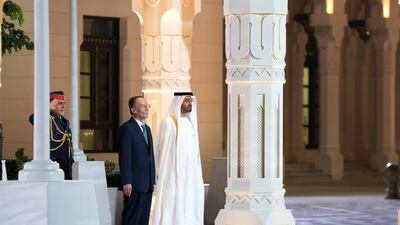 The leaders stand for the national anthem.