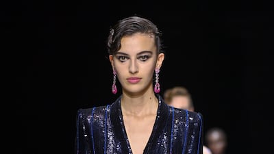Al Zuhair at the Giorgio Armani Prive haute couture show, wearing a sequined tailored jacket over front-pleat satin trousers. Getty