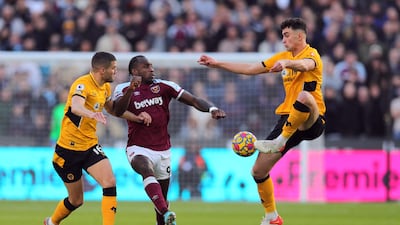 West Ham United's Michail Antonio takes on Wolverhampton Wanderers' Max Kilman and Conor Coady. Reuters