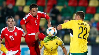 Serbia's Nemanja Maksimovic takes on Lithuania's Karolis Laukzemis during their Group B match in Vilnius. Reuters