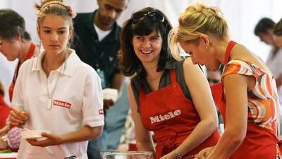 Visitors take part in a cookery school at Taste of Dubai in Dubai Media City Amphitheater in Dubai.