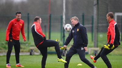 David Moyes of Manchester United challenges Wayne Rooney during the training session on Tuesday. Laurence Griffiths / Getty Images / March 18, 2014