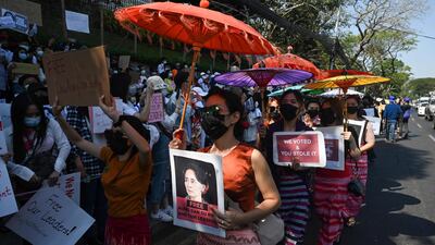 Protesters hold up placards in front of the US embassy in Yangon, Myanmar, during a demonstration against the military coup that occurred in the country on February 1. AFP