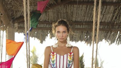 A line of rainbow-hued embroidery gives extra pizzazz to a pinstriped jumpsuit