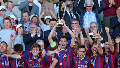 Captain Roger Riera of FC Barcelona, centre, holds the Lennart Johansson trophy after winning the Uefa Youth League Final match between Benfica Lisbon and FC Barcelona at Colovray Stadion on April 14, 2014 in Nyon, Switzerland. Philipp Schmidli/Getty Images