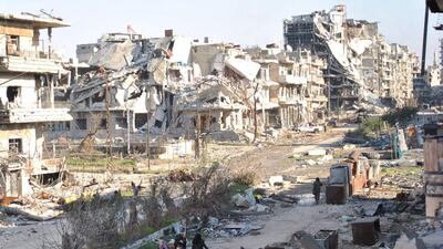 Civilians leave the the besieged Syrian city of Homs as Syria's regime and rebels accused each other of violating a truce. Bassel Tawil / AFP