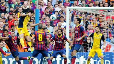 Diego Godin, left, of Atletico Madrid scores the goal that won his team the Spanish Primera Liga title during their match against Barcelona at Camp Nou on May 17, 2014 in Barcelona, Spain. David Ramos / Getty Images