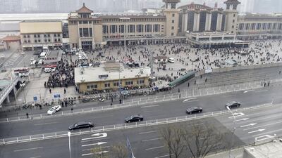 A motorcade, foreground, arrives at Beijing Railway Station in Beijing on Tuesday, March 27, 2018 amid speculation about a visit to Beijing by North Korean leader Kim Jong Un. Kyodo News via AP