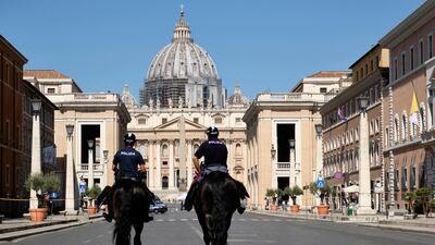 Mounted police officers patrol the street leading to St Peter's Basilica at the Vatican. LaPresse via AP