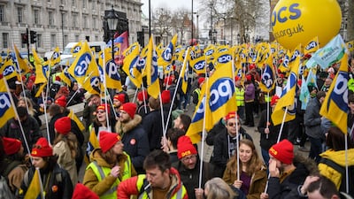 Striking civil servants from the Public and Commercial Services Union march along Whitehall, in central London. Bloomberg