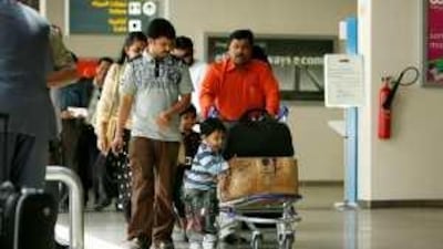 Air passengers arrive at Abu Dhabi Airport.