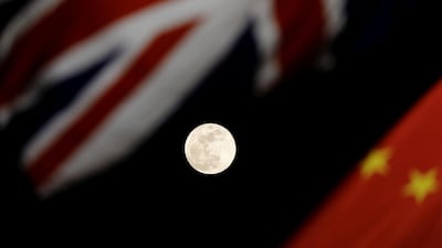 The super blue blood moon is seen between British and Chinese flags raised at Tiananmen square in Beijing as British Prime Minister Theresa May visits China's capital Damir Sagolj / Reuters.