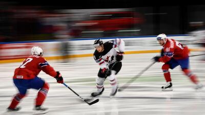 Canada’s forward Claude Giroux dribbles the puck in between Norwegian defenders Henrik Odegaar, left, and Aleksander Reichenberg during the IIHF Men’s World Championship Group B ice hockey match in Paris. Christophe Simon / AFP