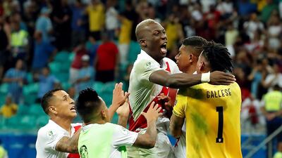 Peru goalkeeper Pedro Gallese is mobbed by teammates after the Copa America quarter-final win over Uruguay. EPA