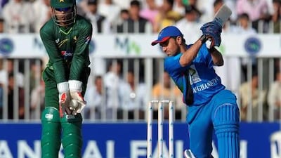 Karim Sadiq is caught by Umar Akmal off the bowling of Shahid Afridi after scoring 40 runs in Sharjah on Friday.