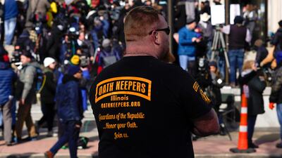 A man wearing an Oath Keepers shirt stands outside the Kenosha County Courthouse in Kenosha, Wisconsin. AP