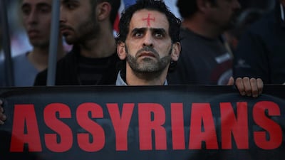An Assyrian man walks in solidarity with Christians abducted in Syria and Iraq. Hussein Malla / AP Photo