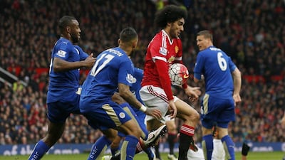 Manchester United midfielder Marouane Fellaini, in red, in action against Leicester City. Jason Cairnduff / Reuters