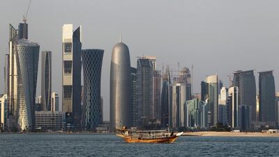 A traditional dhow floats in the Corniche Bay of Doha, Qatar, with tall buildings of the financial district in the background. AP Photo
