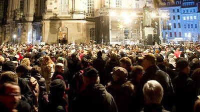 Germany: People are seen in front of the Dresden Frauenkirche as they attend the 21st Christmas vesper in Dresden, eastern Germany. AFP Photo / DPA / Sebastian Kahnert