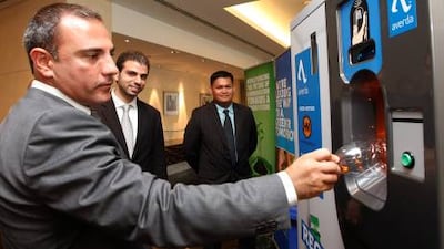 Wadih Shamma, the general manager Levant of RMS Outdoor, demonstrates a Reverse Vending Machine.