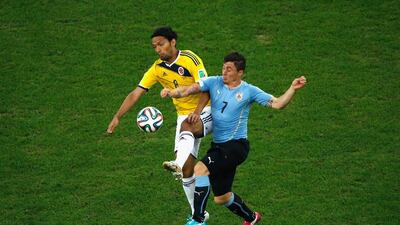 Abel Aguilar of Colombia and Cristian Rodriguez of Uruguay compete for the ball during their last-16 match on Saturday at the 2014 World Cup. Fabrizio Bensch / Getty Images