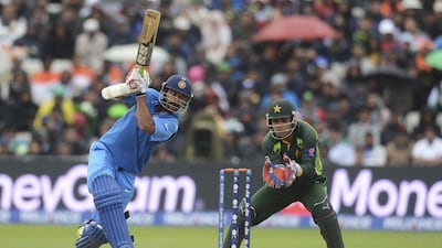 Shikhar Dhawan, left, and Kamran Akmal shown during an India v Pakistan 50-over match at the 2013 ICC Champions Trophy in Birmingham, England. Philip Brown / Reuters / June 15, 2013