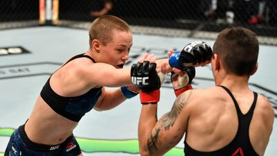 Rose Namajunas, left, punches Jessica Andrade of Brazil in their strawweight fight during the UFC 251 event at Flash Forum on UFC Fight Island on July 12, 2020 on Yas Island, Abu Dhabi, United Arab Emirates. Jeff Bottari / Zuffa LLC / Getty Images