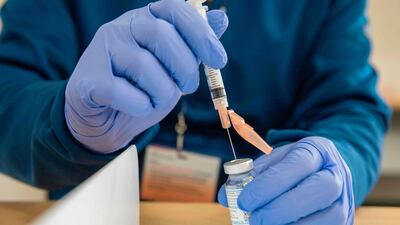 Pharmacist fills syringes with the Moderna Covid-19 vaccine. AFP