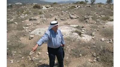 Abdul Rahman Kayyal, who lost his home during an Israeli incursion, stands at the cemetery in al Birwa.