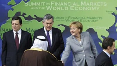 The German Chancellor Angela Merkel shakes hands with the Saudi King Abdullah Al Saud as they take their places for the family photo next to the EU Commission President Jose Manuel Barroso, left, and the British Prime Minister Gordon Brown and the French President Nicolas Sarkozy at the opening of the G20 Summit on Nov 15, 2008 in Washington, DC.
