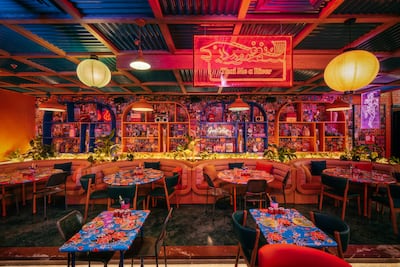 The restaurant's kitschy decor is meant to transport diners to a Bangkok night market. Photo: Sip Song