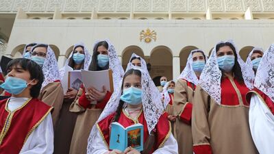 Members of a choir sing during a Christmas mass for the Armenian Orthodox in the Lebanese town of Antelias, north of Beirut. AFP