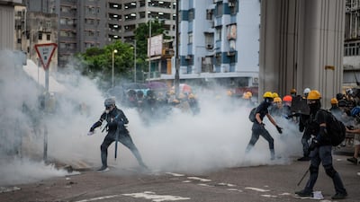 A protester pours liquid onto a tear gas canister during a demonstration in the district of Yuen Long on July 27, 2019 in Hong Kong, China. Getty