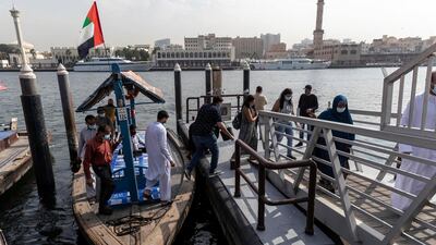 People step off an abra in Dubai. Antonie Robertson / The National