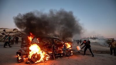 A destroyed vehicle in flames following an Israeli air strike in south-west Gaza City on April 8. EPA