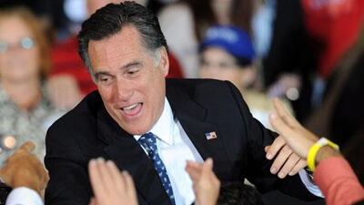 Republican presidential candidate Mitt Romney addresses supporters with wife Ann and sons Tagg, Craig and Ben after winning the New Hampshire primary.