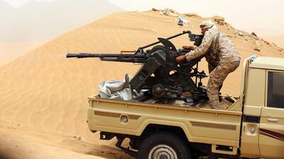 A Yemeni tribesman from the Popular Resistance Committees, militias that support Yemen's internationally recognised government, manoeuvres a gun mounted on a pickup truck during fighting against Houthi rebels and their allies on June 30, 2017 in the area of Sirwah, west of Marib city. Abdullah Al Qadry / AFP