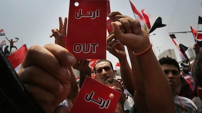 Egyptian protesters give the President Mohammed Morsi the red card. Spencer Platt / Getty Images