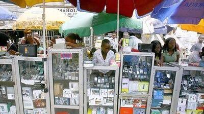 Mobile phone vendors, above, in Lagos, Nigeria, where the embrace of technology has brought the country into fund managers' focus. Issouf Sanogo / AFP