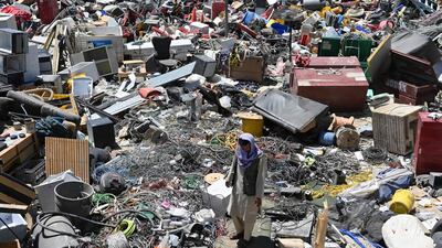 A man selects valuable items at a recycling workshop near the Bagram Air Base. AFP