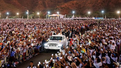 Pope Francis greets followers from a car after leading a holy mass in Dili, East Timor. Reuters