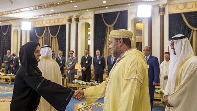 Najla Al Awar, Secretary General of the Cabinet Affairs Minister, left, greets King Mohammed VI of Morocco, second right. Sheikh Mohammed bin Zayed, Crown Prince of Abu Dhabi and Deputy Supreme Commander of the Armed Forces, right, looks on. Mohamed Al Hammadi / Crown Prince Court - Abu Dhabi