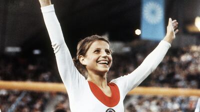 Olga Korbut of Russia throws up her arms in joy after winning the Individual Women's Gymnastic event at the 1972 Summer Olympics in Munich, Germany, in 1972. AP Photo