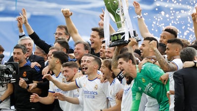 Marcelo holds the trophy and celebrates with teammates. Reuters