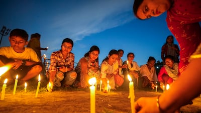 Women light candles as they stage a silent protest against the rape and killing of a trainee doctor at a government hospital in Guwahati, India. AP